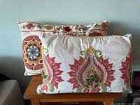 Both embroidered lumbar pillows front view