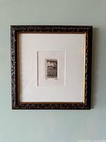 Full view of framed etching on wall