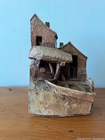 Front view showing cottages, quay and boat