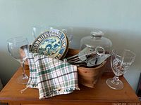 Overall lot showing basket with plates, tools, glasses and dome