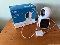 Both cameras together with box and power adapter visible