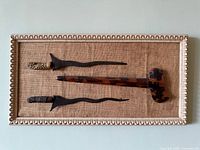 Framed display showing two Kris daggers and sheath