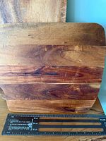 Square laminated striped board next to ruler