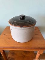 Front view of crock showing body, rim and lid color contrast