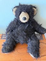 Front view of black Mary Meyer bear sitting upright