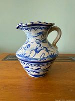 Front view of blue and white ceramic pitcher showing pattern and shape