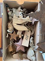 Top view of the box showing mix of wooden, metal, pinecone and fabric ornaments