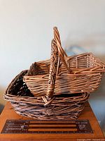 Both rectangular wicker baskets stacked showing size and handles