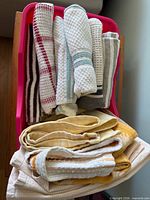 Top view of basket showing rolled waffle-weave towels and folded yellow towels