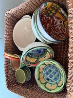 Ceramic bowls and dishes stacked in woven basket