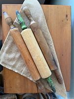 Three rolling pins on cloth, full view