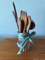 Utensils grouped in mason jar with ribbon