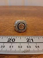 Front view of Winnipeg Jets ring with logo and ruler for scale