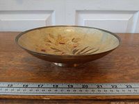 Side view of brass pedestal bowl showing height, diameter ruler for scale