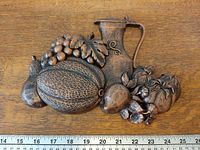 Front view of plaque with scale showing width