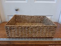 top oblique view showing overall basket shape and weave pattern next to ruler