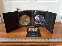 Digipak opened showing DVD, CD, booklet and tracklist panel