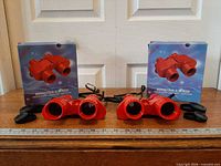 Both binocular sets with boxes, caps, straps, ruler for scale