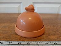 Front view of garlic baker showing dome lid on circular base