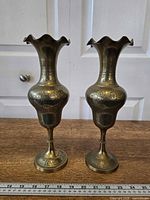 Front view of both brass vases with ruler for scale