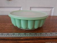 Side view of assembled mint green mold with lid in place