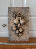 Full view of rectangular plaster plaque against door, ruler for scale