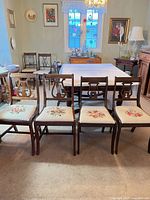 Four mahogany lyre-back chairs in dining room