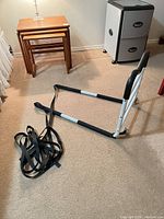 Bed assist rail frame, strap coiled beside