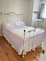 Full view of bed frame with mattress and bedding