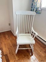 Front view of white spindle-back wooden rocking chair