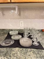 Group view of mugs and assorted saucers on countertop