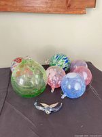 Front view of seven hand-blown glass ornaments on table