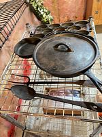 All cookware and utensils on wire shelf