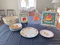 Entire lot on table showing mixing bowl, stacked plates, platter, pink plate, decorative plaques and glass charger