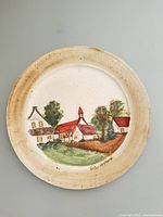 Front of hand-painted village scene ceramic plate