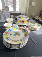 Full set displayed on table including plates, bowls, tureen and accessories