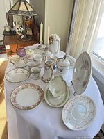 Overview of assorted porcelain dishes and glass tumbler on table
