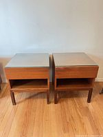 Front view of both matching wood end tables with glass tops