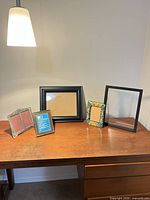 All five picture frames arranged on desktop