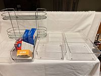 Overall lot showing chrome rack, three acrylic organizers, boxed contents