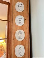 All four Piet Hein ceramic plaques hanging vertically showing size, shape and artwork