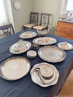 All nine silverplate serveware items displayed on table