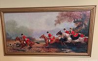Wide view of fox hunt print in gold frame