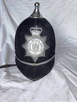 Front view showing badge plate, finial, chin strap