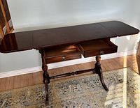 Table with both leaves extended, drawers open showing interior