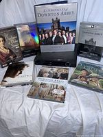 Group shot of Sylvania DVD player and six DVD titles