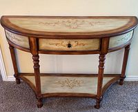 Full view of demi-lune console table showing overall design, turned legs, drawer, and lower shelf