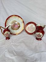 Group shot of two plates and two vases showing design coherence and relative sizes