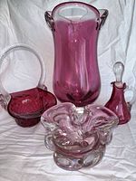 Group shot of all four pink/cranberry glass pieces