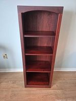 Front view of shelf showing four shelf spaces and dark cherry finish